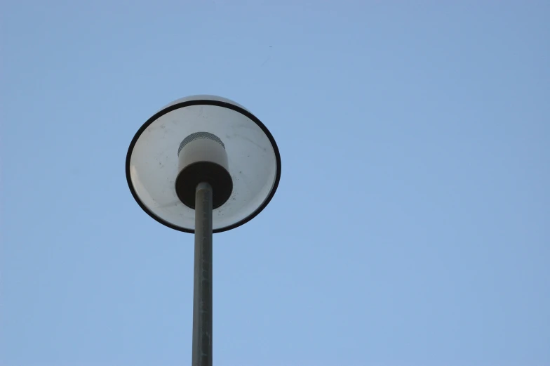 a light pole with a circular light bulb below