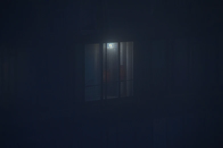 blurry image of night and light coming through the window of a dark room