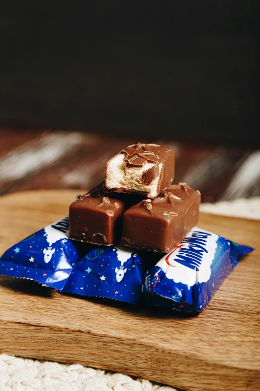 four pieces of candy on top of a wooden tray