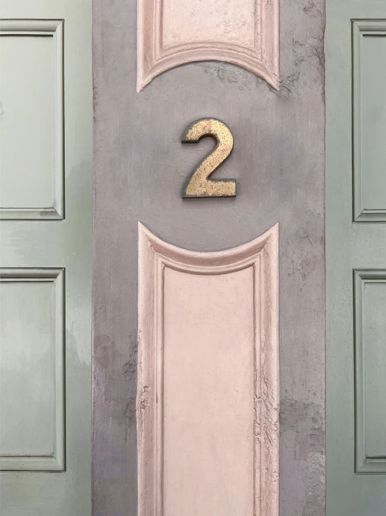 a yellow number is on the bottom half of a door