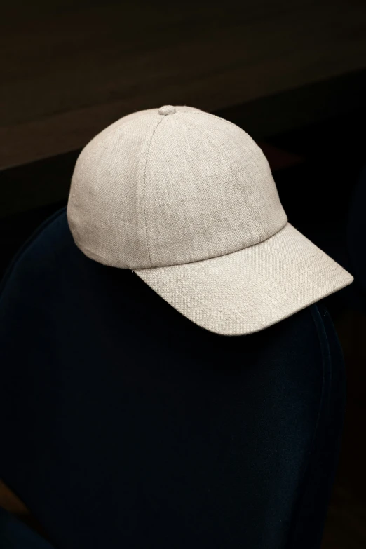 a baseball cap on a black cloth covered chair