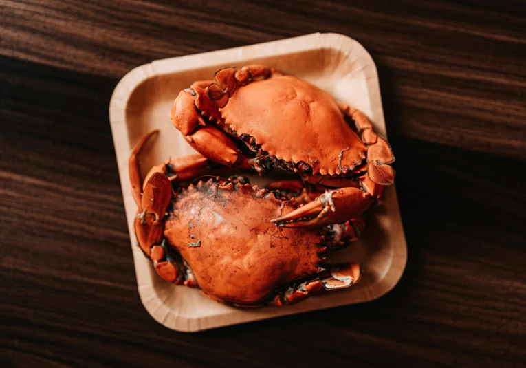 a cooked crab with other ingredients on the table