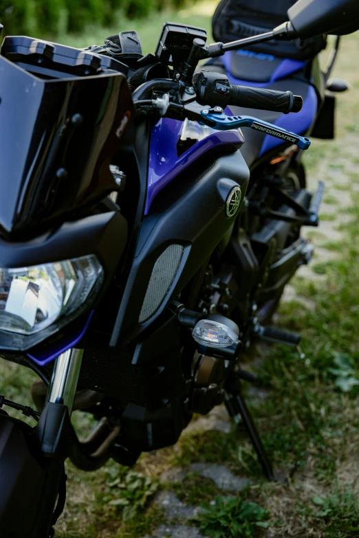 a blue motorcycle is parked in the grass