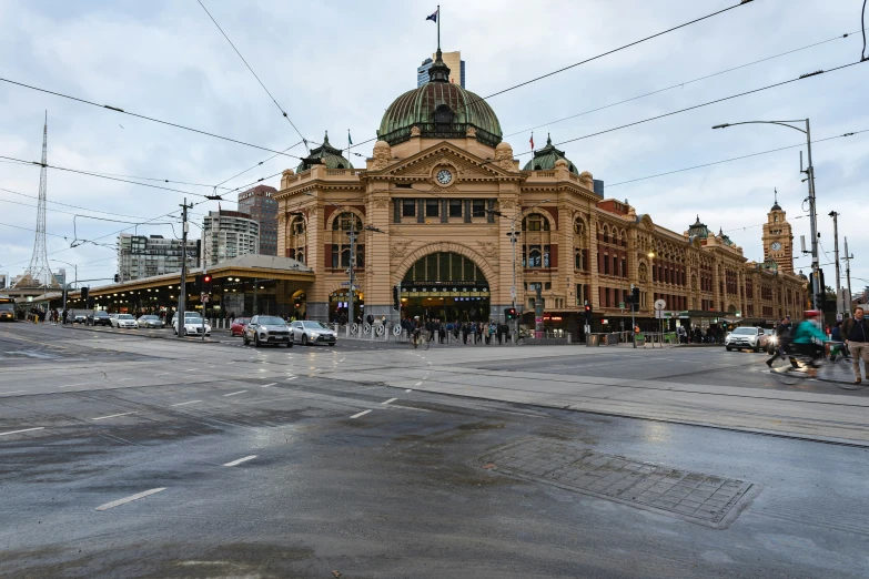 a train station and some cars on a street