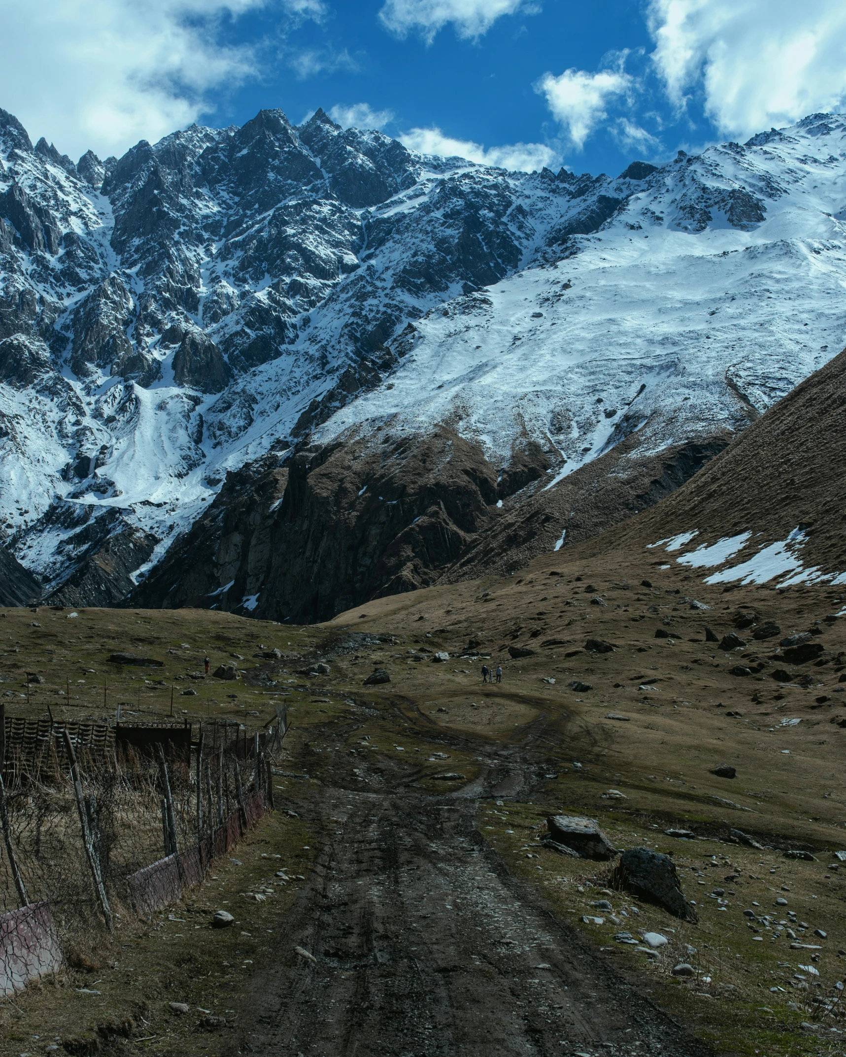 an arid landscape with a trail leading up a mountain