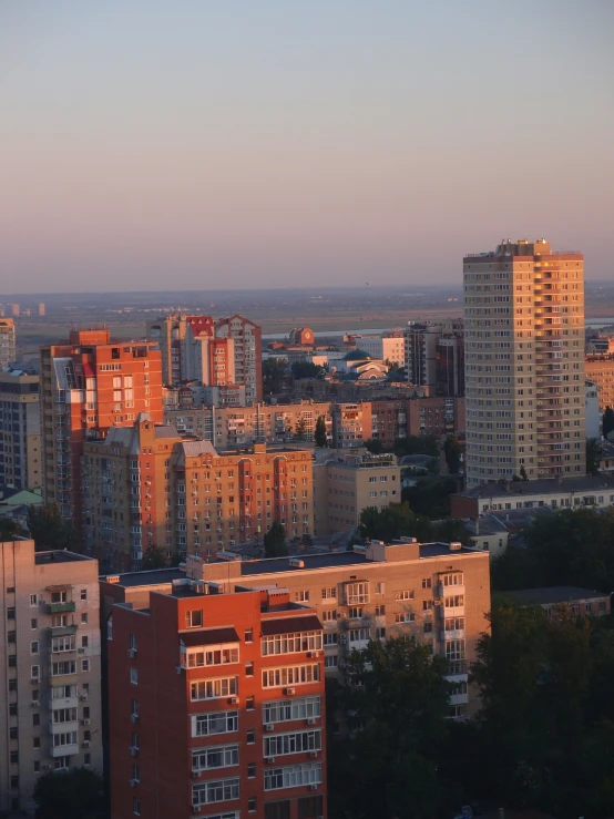 several different buildings in an area with a distant skyline