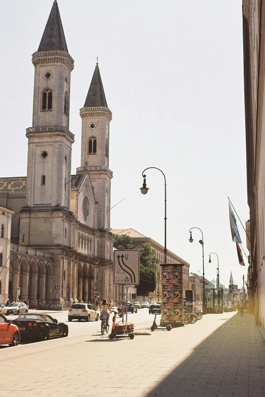 this is a po of an old city with cars parked outside the buildings