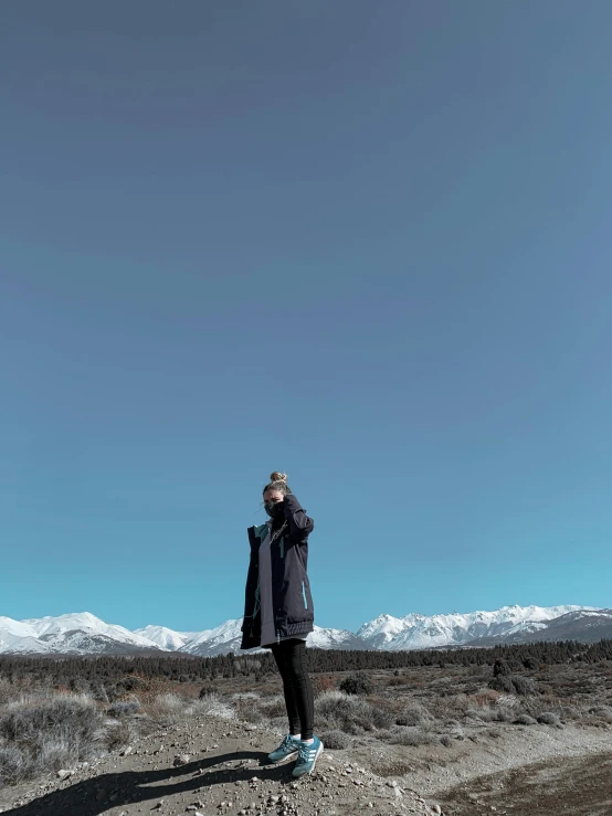 a man standing on top of a dirt field