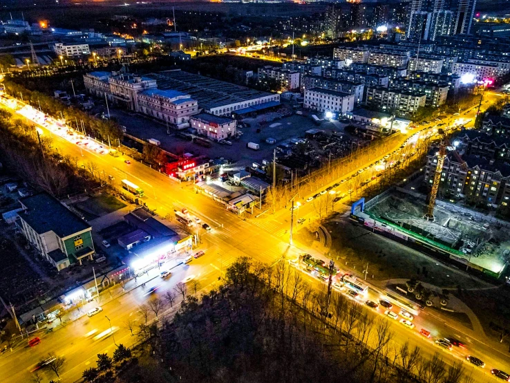 an aerial view of a city at night with traffic moving