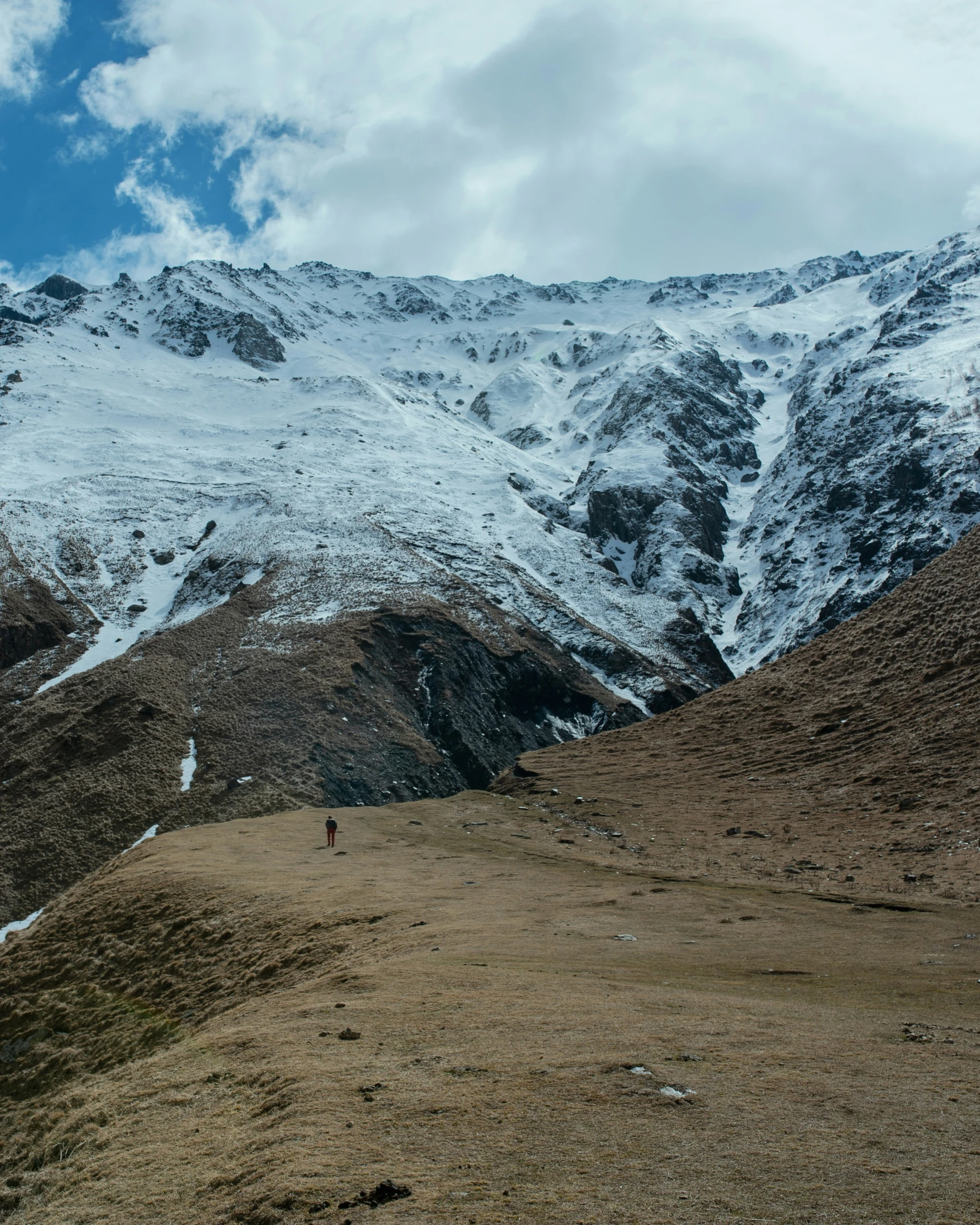 the mountain is covered in snow as someone walks