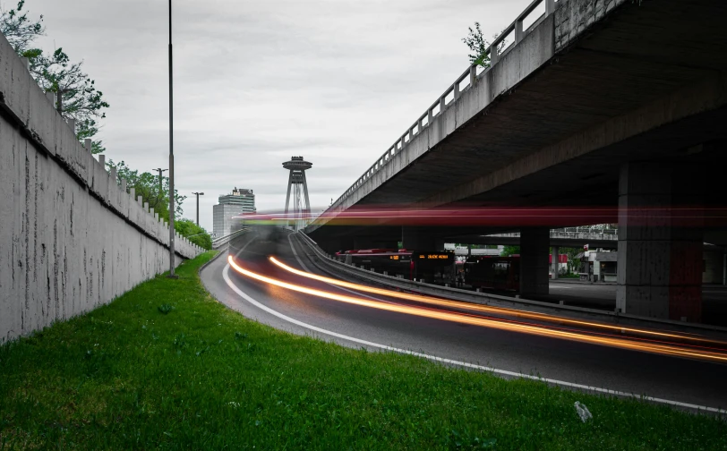 lights from the cars passing by are blurry near a wall