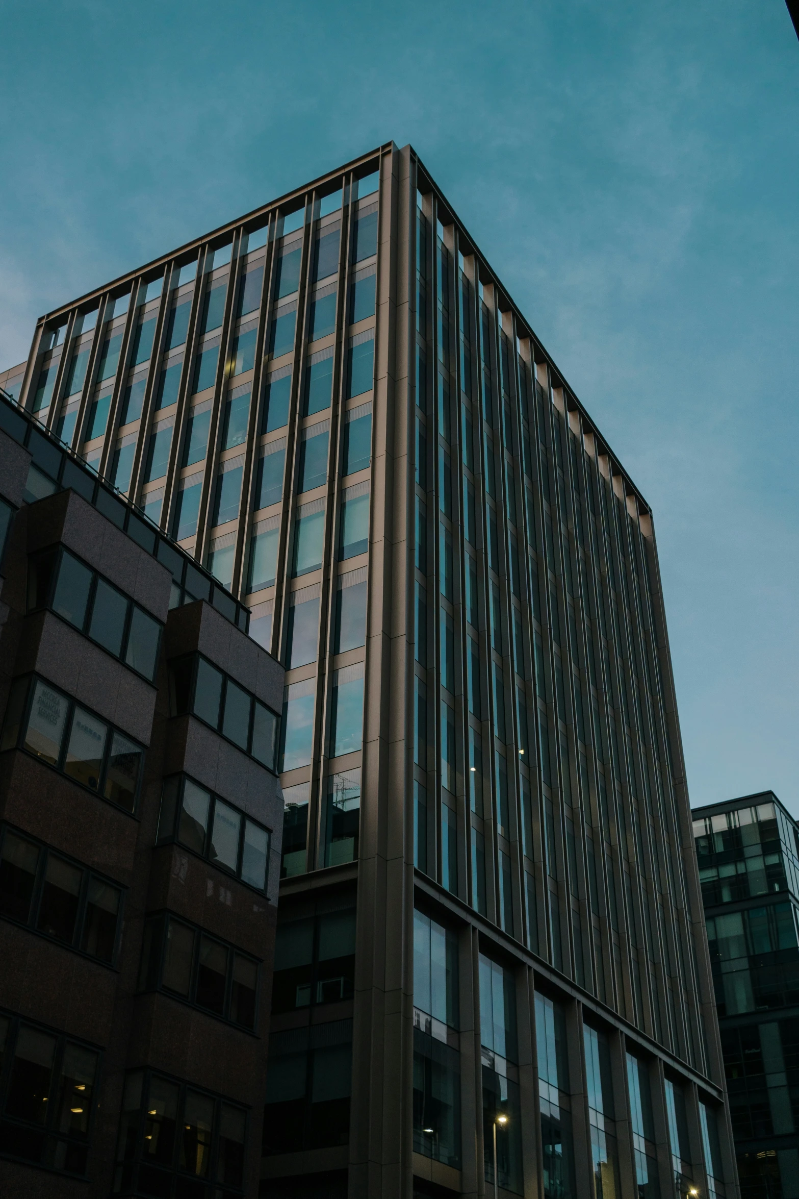 a building sitting on the side of a street with many windows