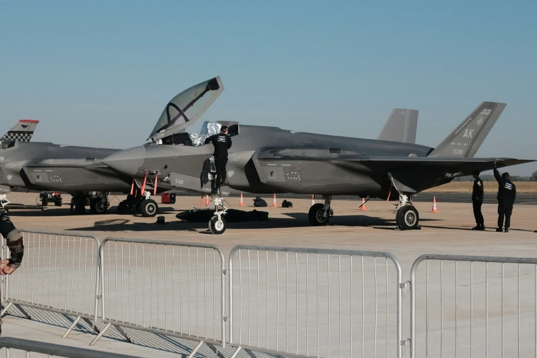 a military plane parked in a hangar next to a gate