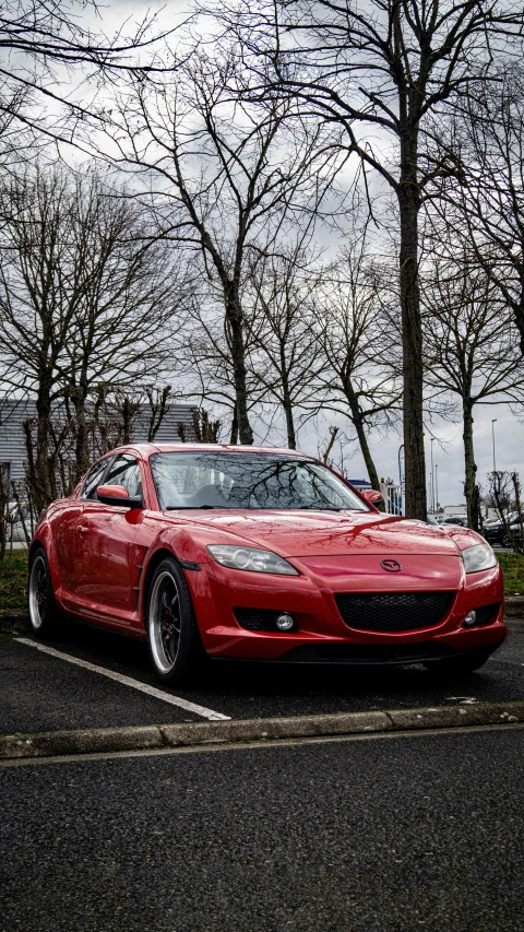 the red sports car parked in the lot