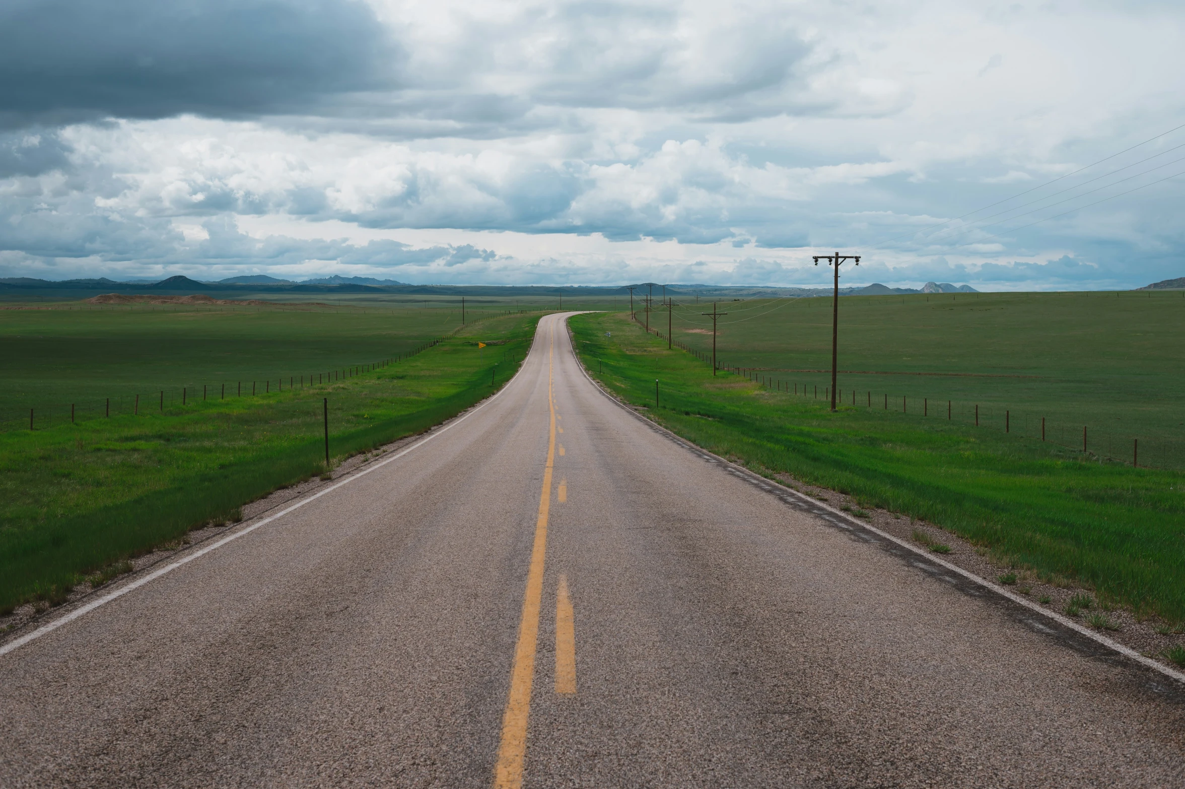 a deserted road with no cars on the way to nowhere