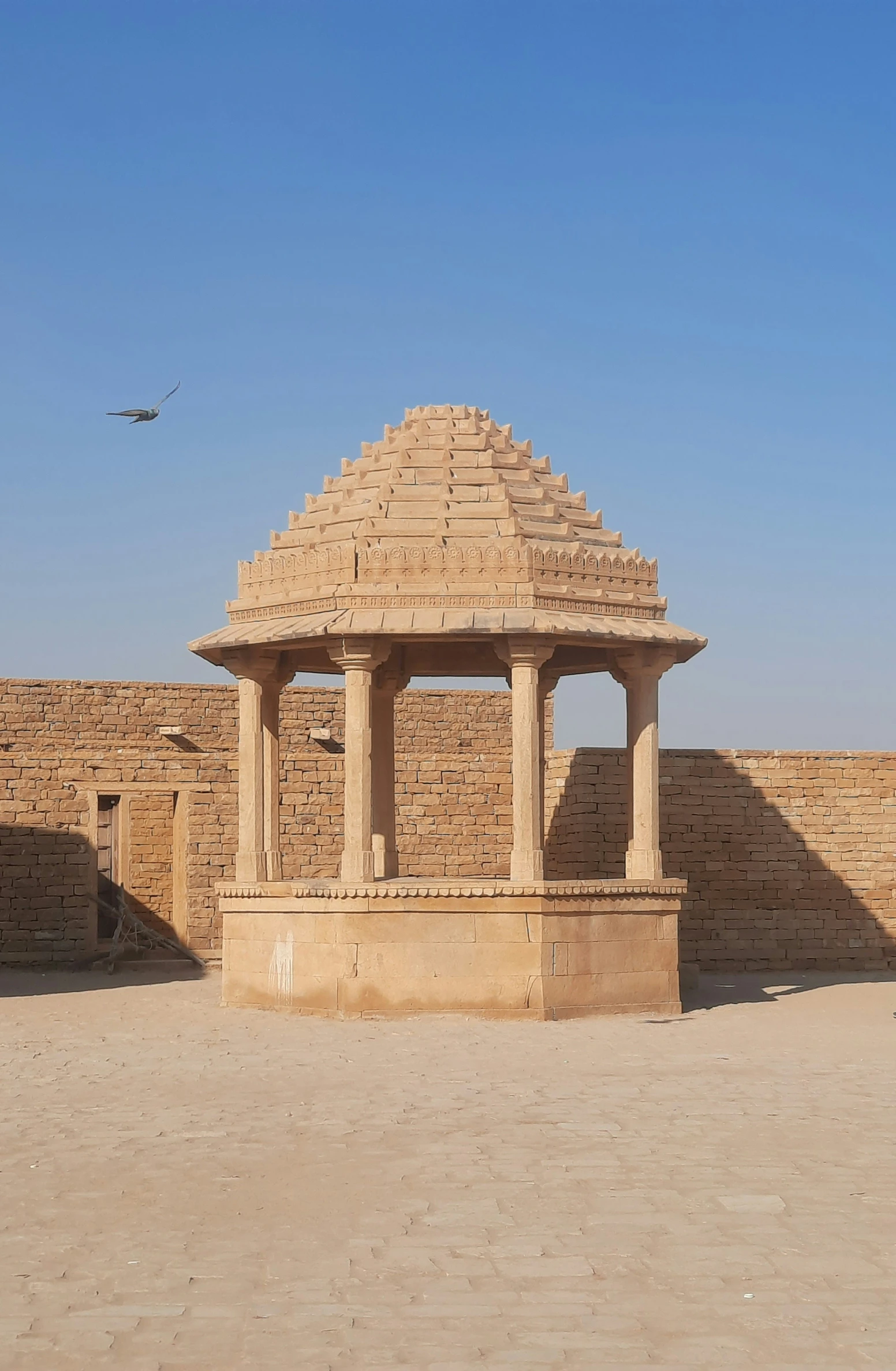 an ancient building made out of bricks near a bird