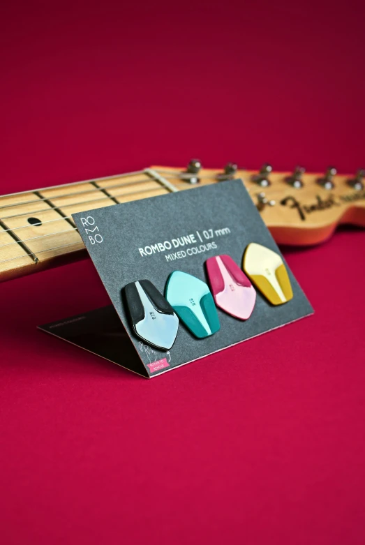 a guitar pin with some colorful shapes