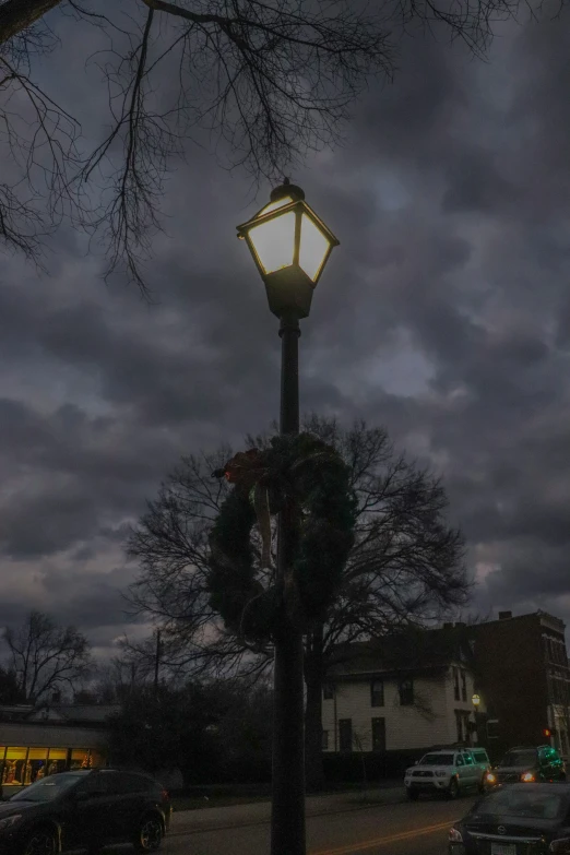 a street lamp sitting under a dark cloudy sky