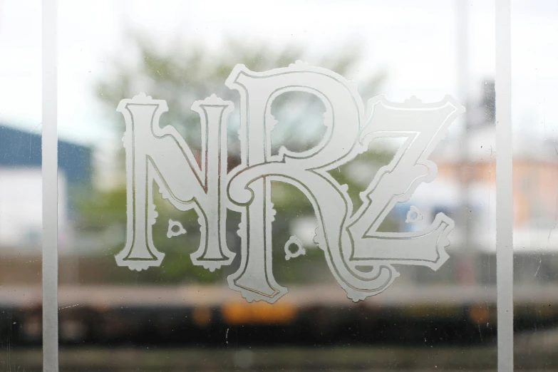 the letters of the word rz are etched into frosted glass