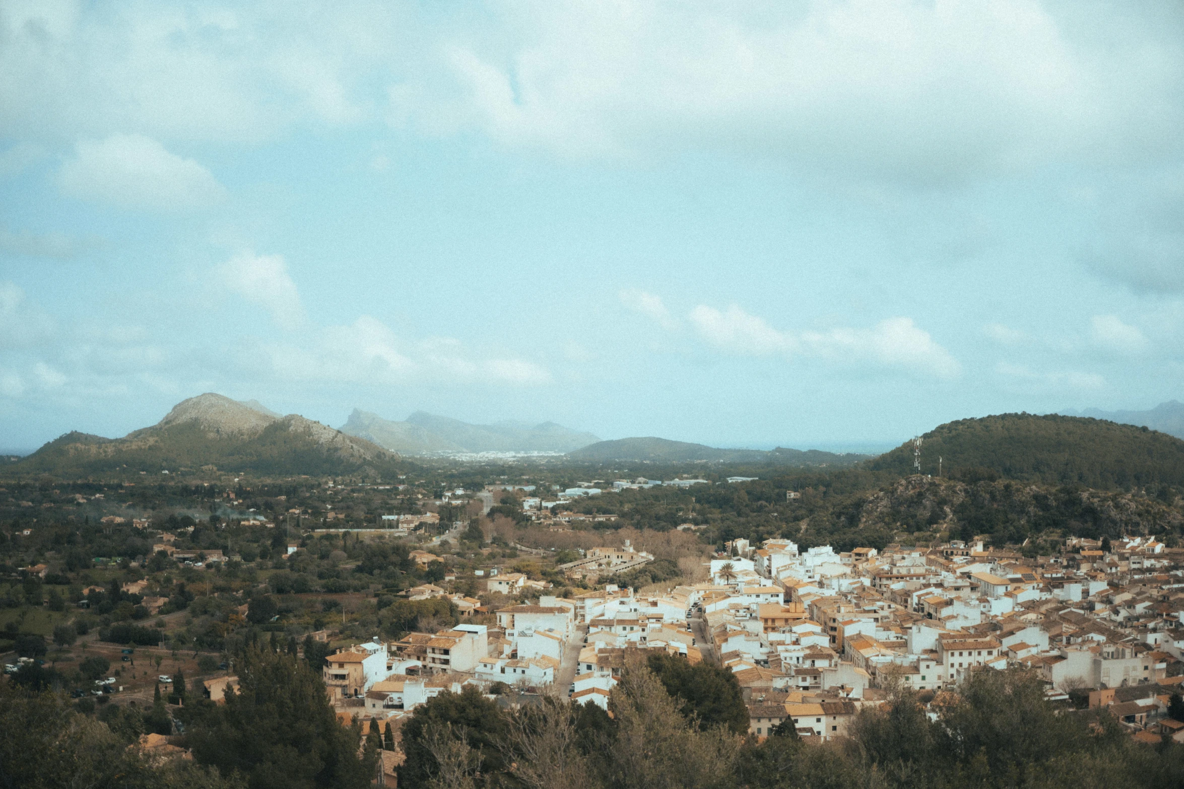 the small town of anura with mountains in the background