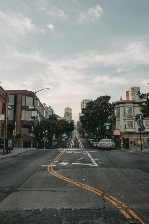 cars are seen driving down the empty street