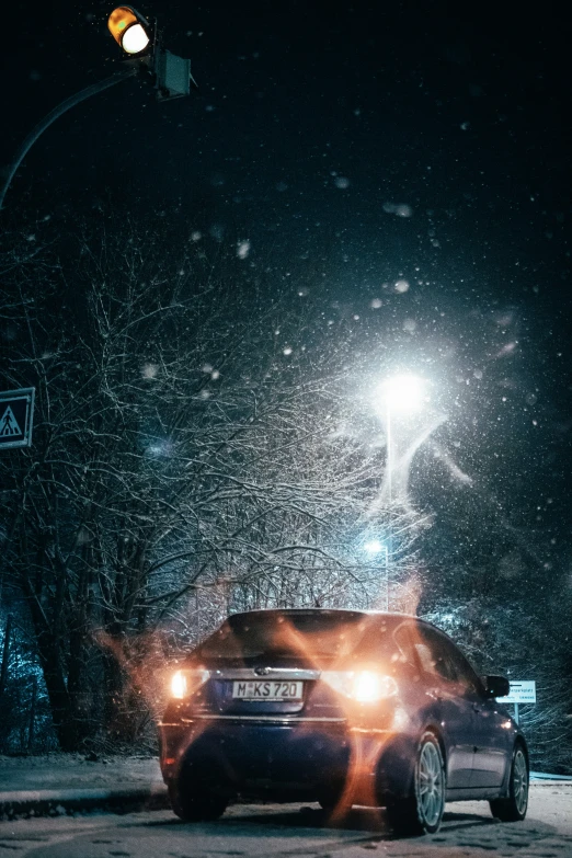 a car at night driving down the street