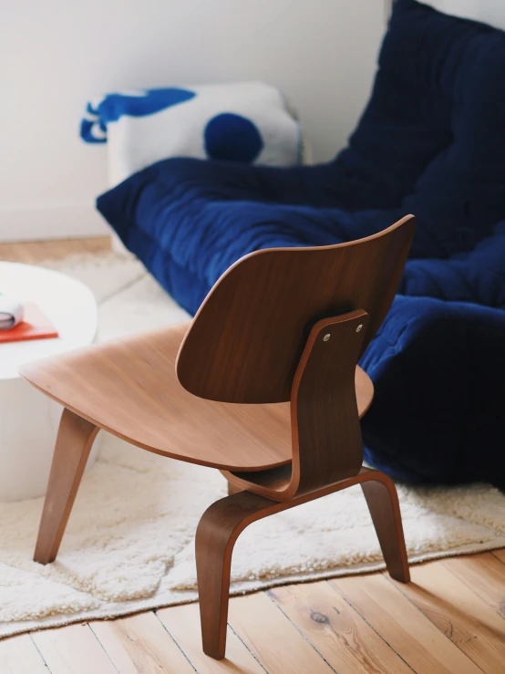 a living room with wooden furniture and a blue couch