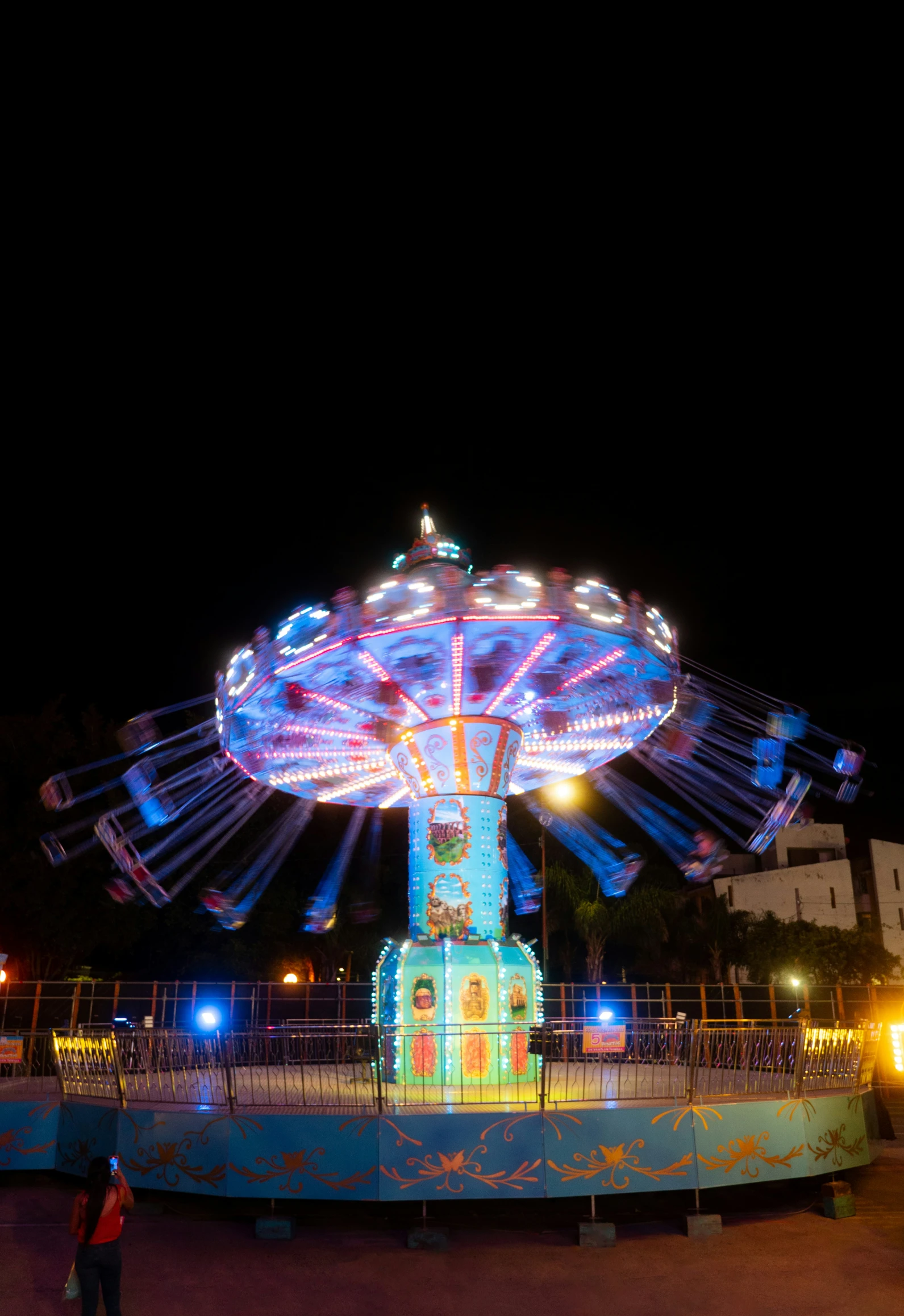 a lit up amut rides at night with people