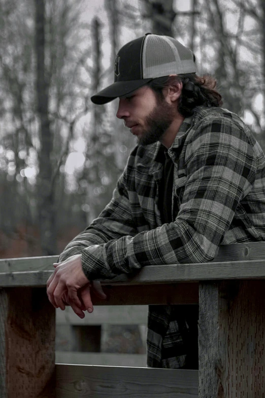 a man is sitting at a bench looking back