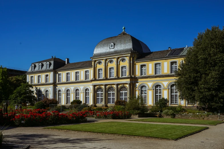 an old yellow mansion on a bright sunny day