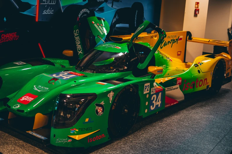 a green car with colorful lettering is on display