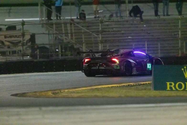 a racing car sitting on the side of the road