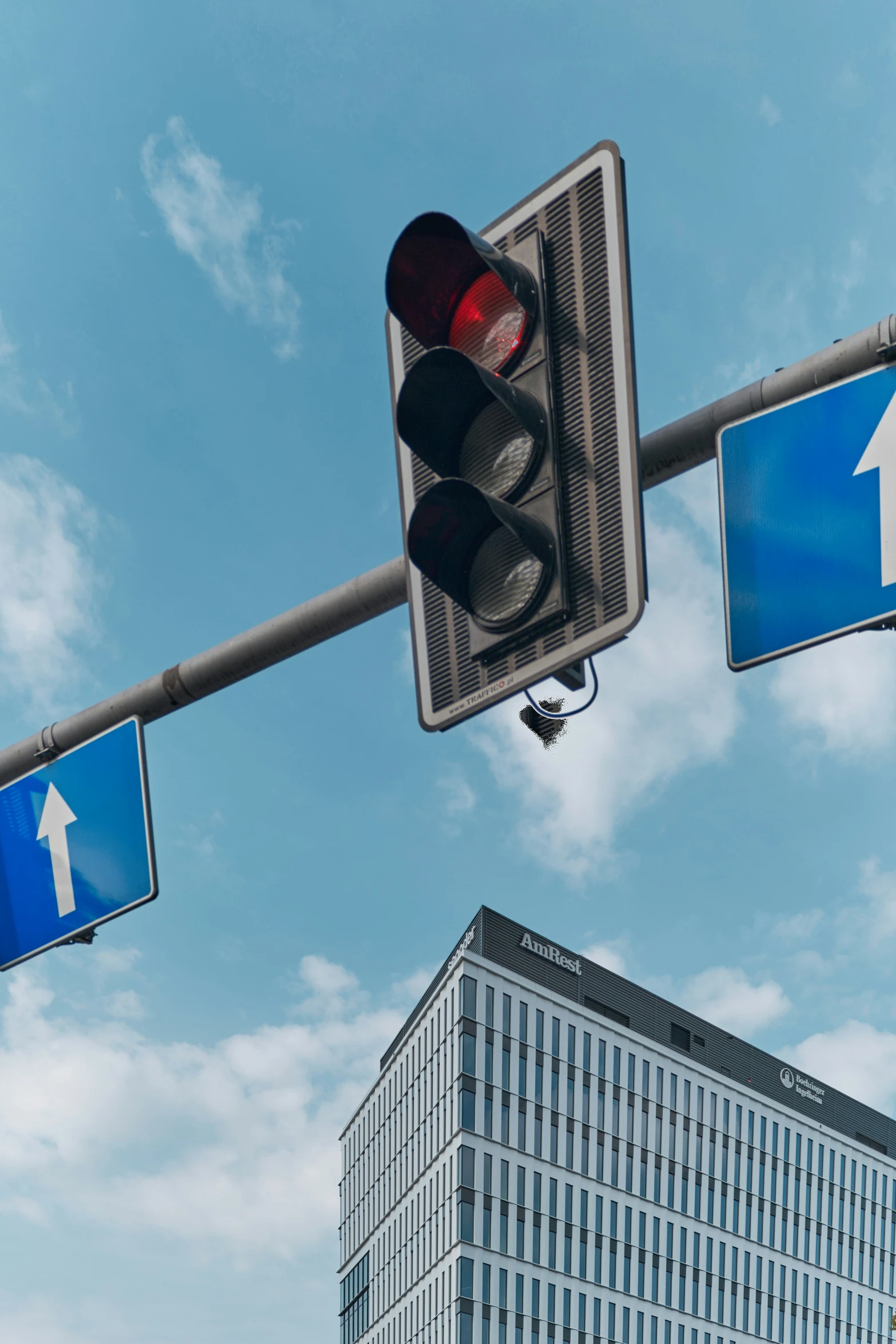 a red traffic signal on a busy city street