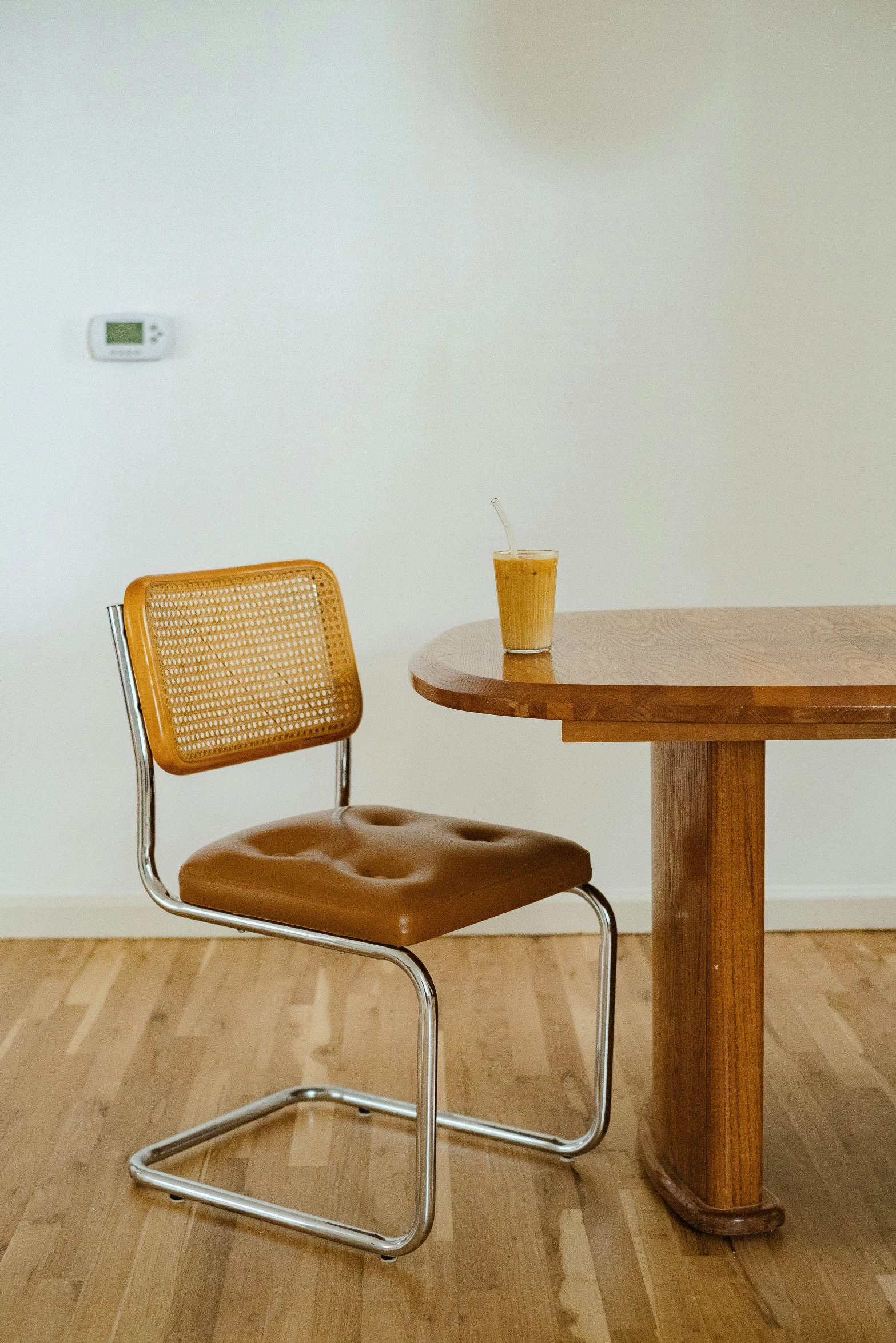 a brown chair sits in front of a table