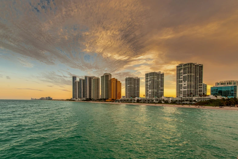 a view from the water at a city next to buildings