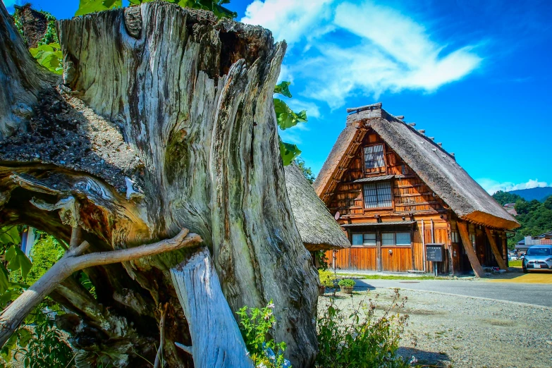 a wooden house with many shingled roofs in the daytime