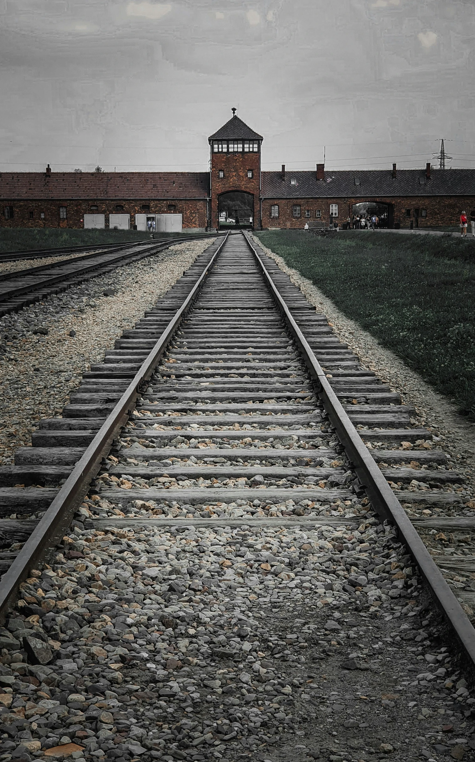 the long train tracks lead toward the railroad platform