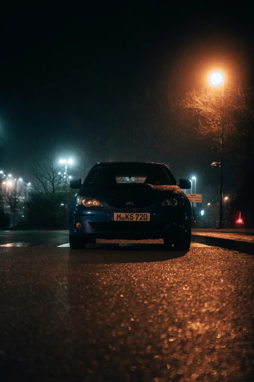 a car parked on a street next to a nightlight