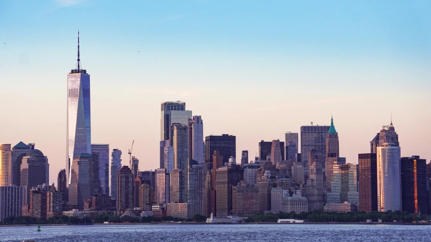 a city skyline in front of a large body of water