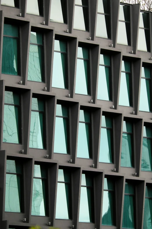 a view of a building with glass windows reflecting the sky