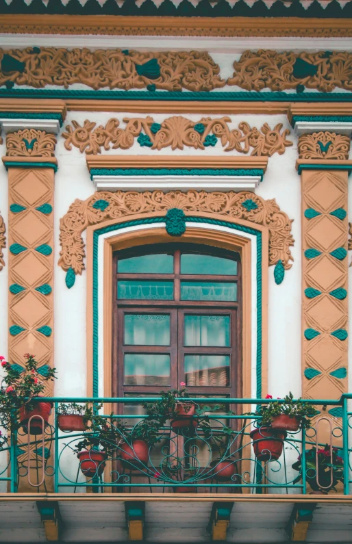 some pots of flowers on top of the balcony of a building