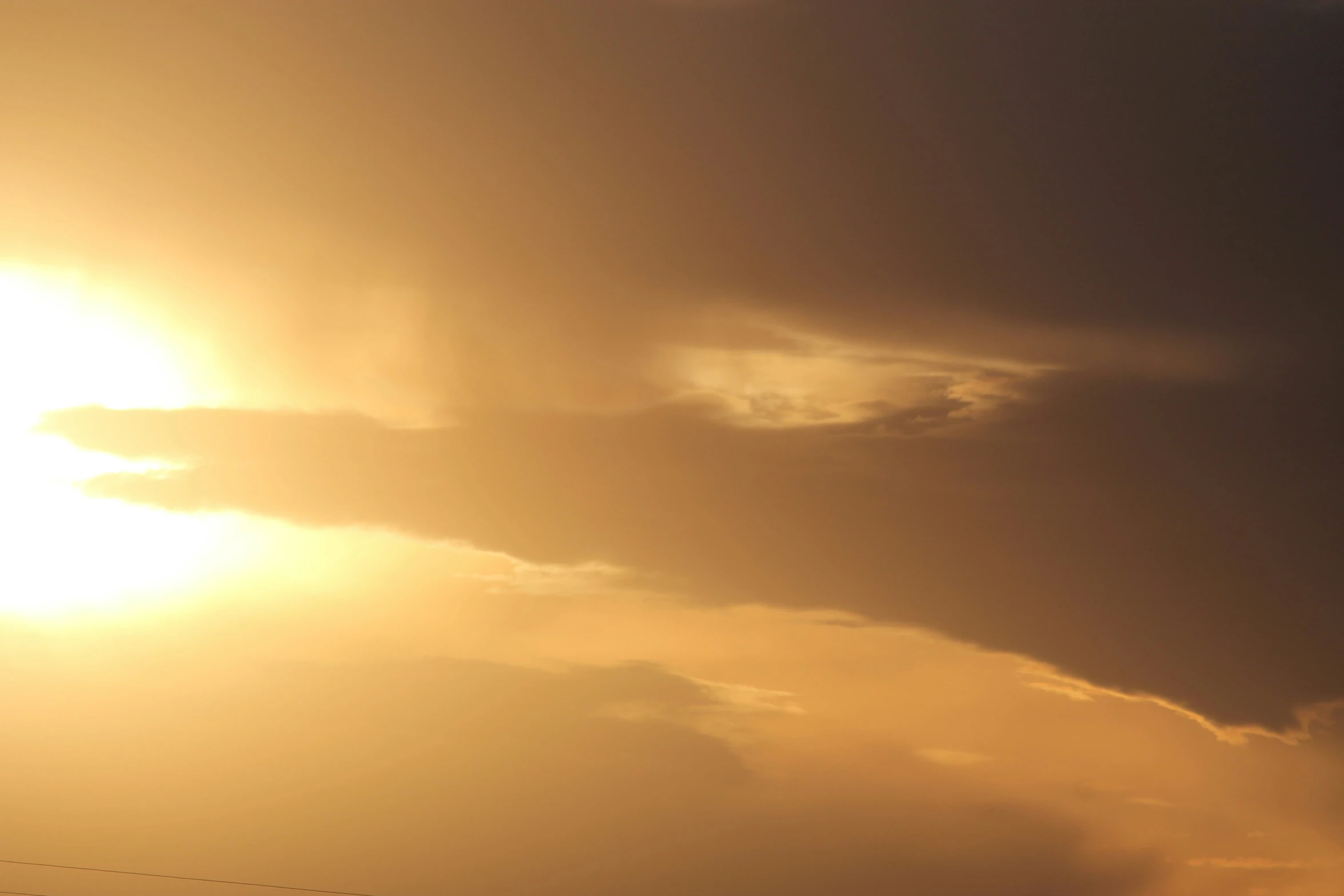 a large passenger jet flying under a cloud filled sky