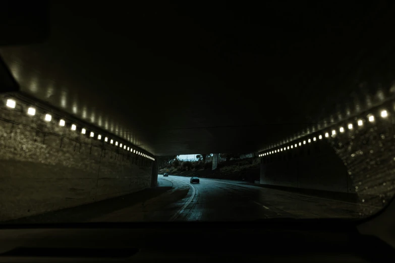 the view from inside a car going through an arched tunnel