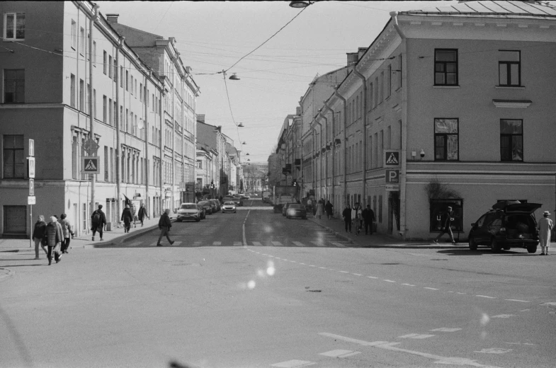 an old po of people walking down a street