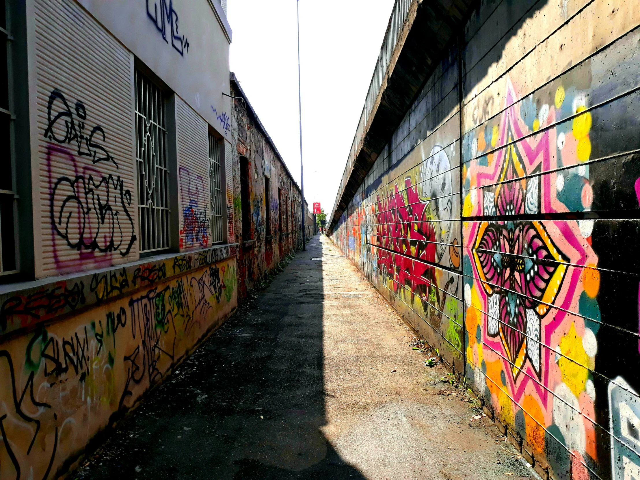 a very long walk that has a lot of graffiti on it