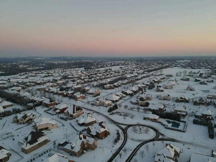 a city is covered in snow in the early morning hours