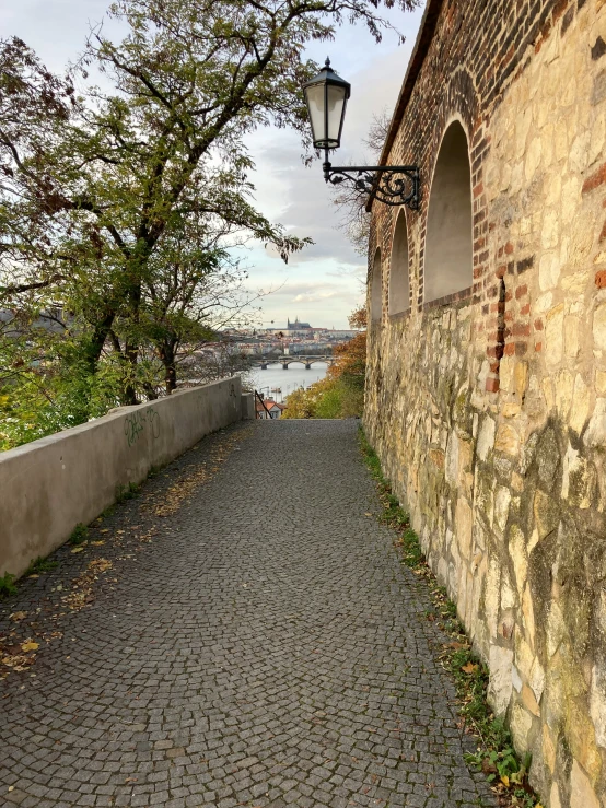 a road beside brick buildings with a street light on each side of it