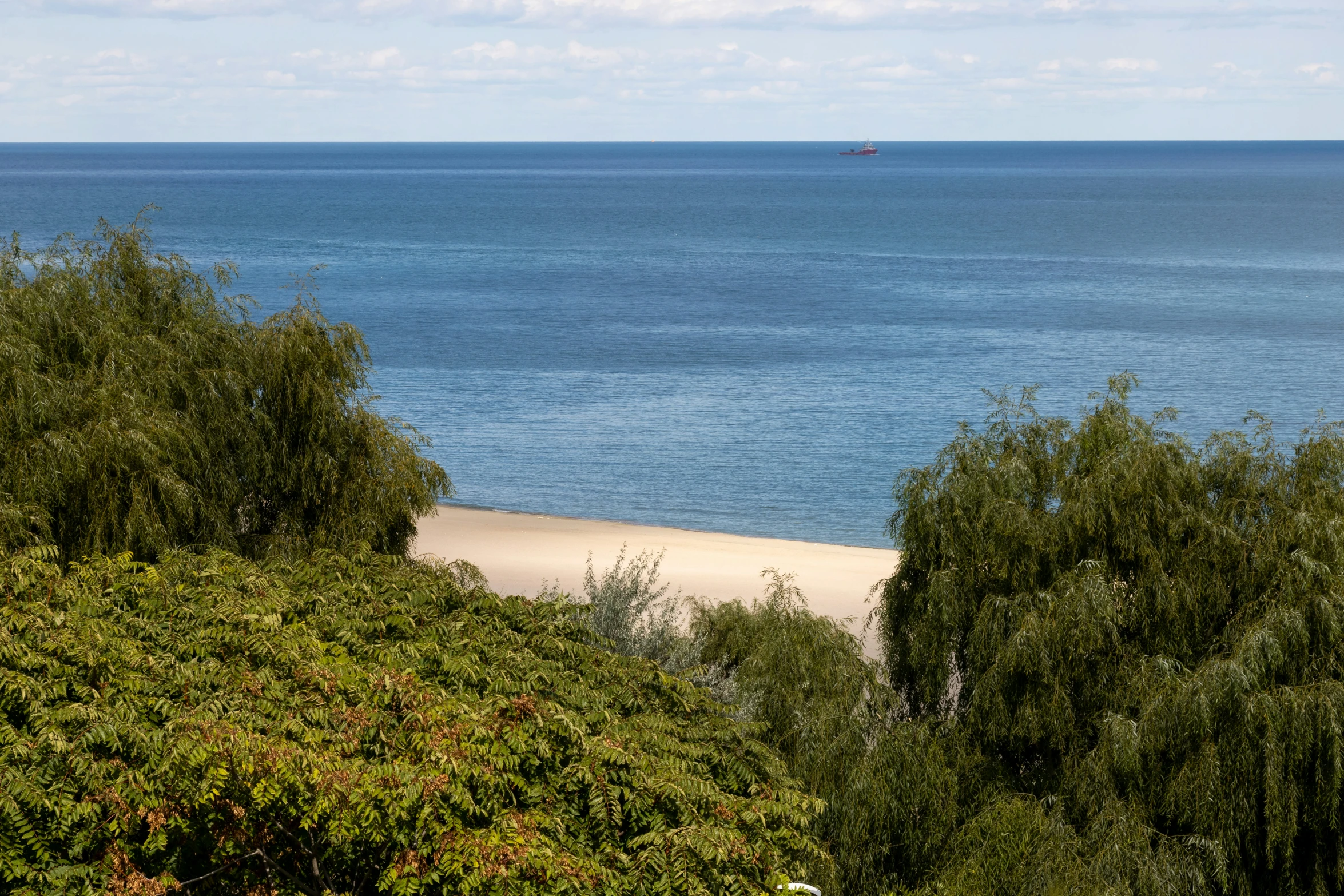 an ocean view with a boat out in the distance