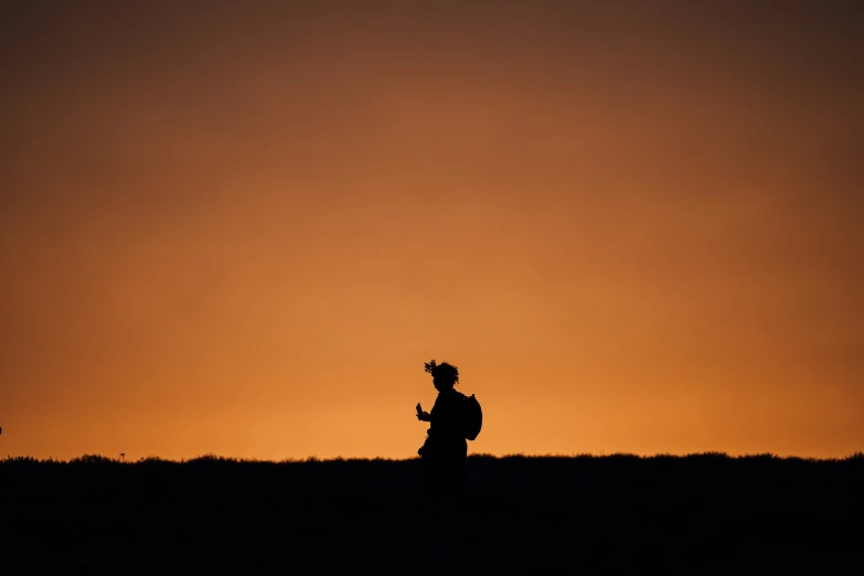 two men standing in the middle of a field