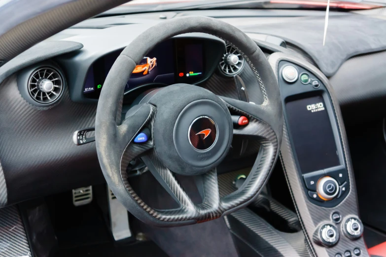 a close - up of the steering wheel and dashboard in a sports car